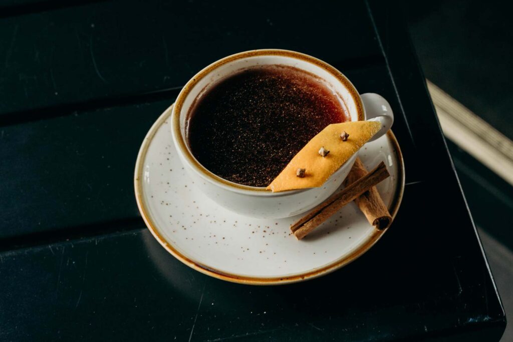Hot, mulled drink in a mug on a saucer