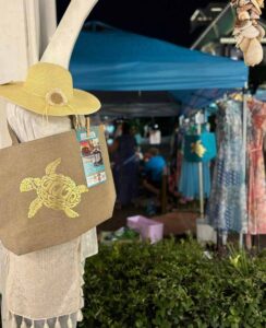 Beach-themed hat and bag hanging from tree